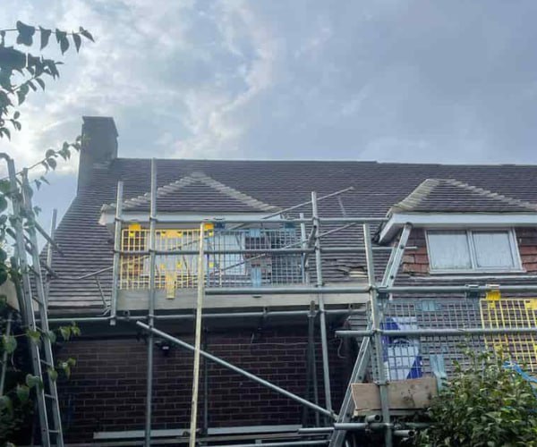 This is a photo of a roof with two dormers that is having some damaged tiles replaced. Works carried out by DSC Roofing Rushden